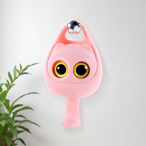 Cute wink cat adhesive coat hook securely holding keys on a bedroom wall.