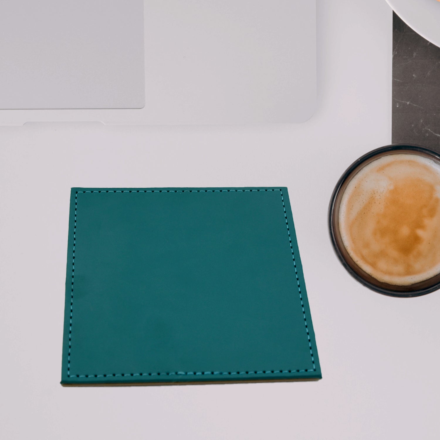 Close-up of a single brown leather coaster, highlighting the material quality and fine stitching.