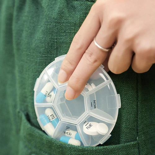 7-sided portable pill box with clear lids showing organized daily compartments