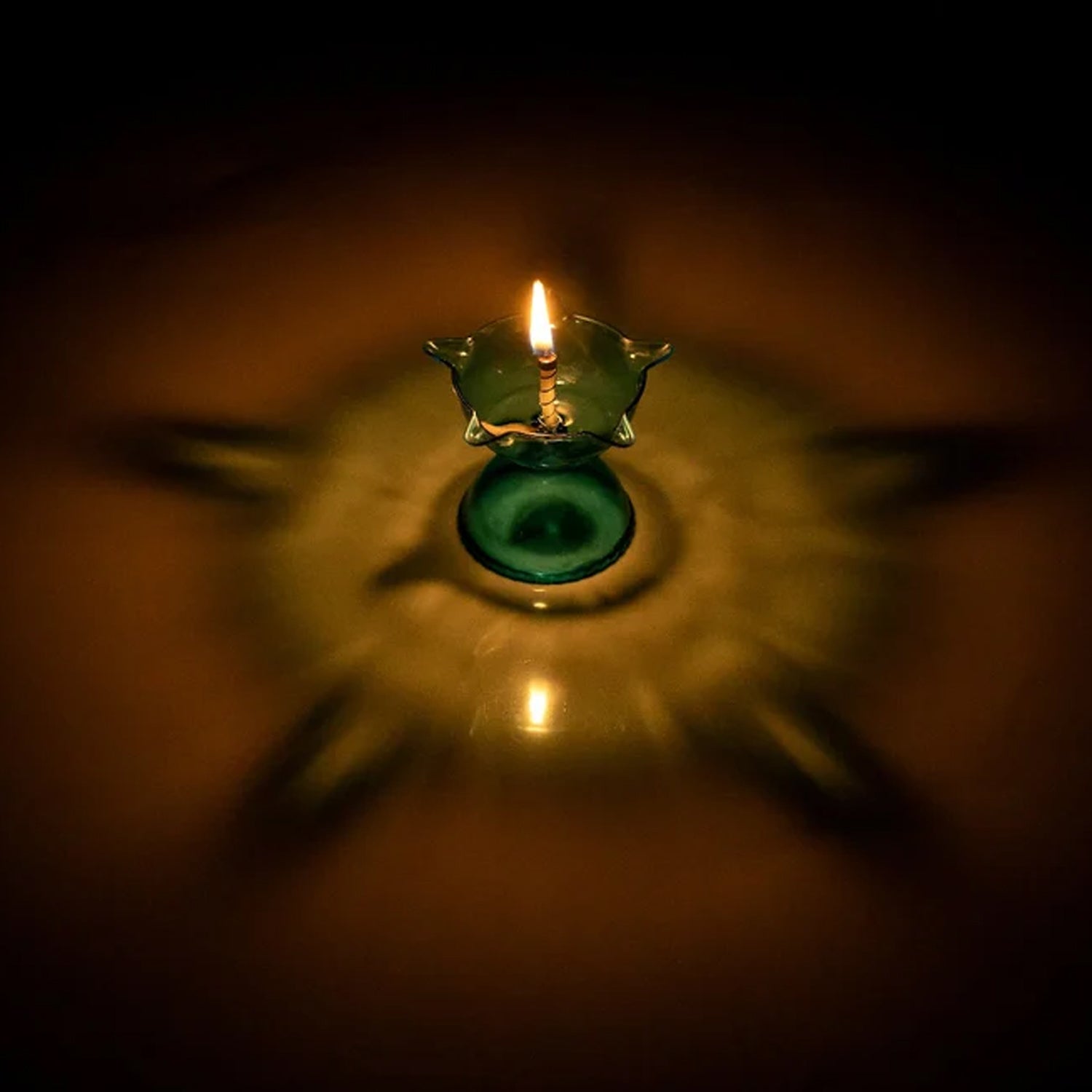 A single multi-shape Reflection Diya showcasing its unique design and bright illumination.