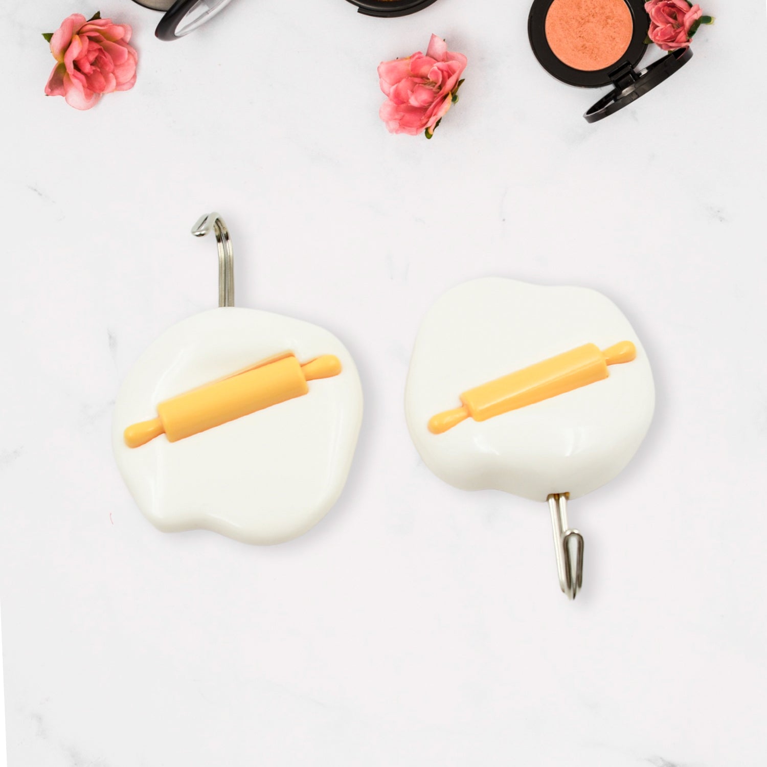 Multipurpose self-adhesive hooks organizing kitchen utensils and towels.