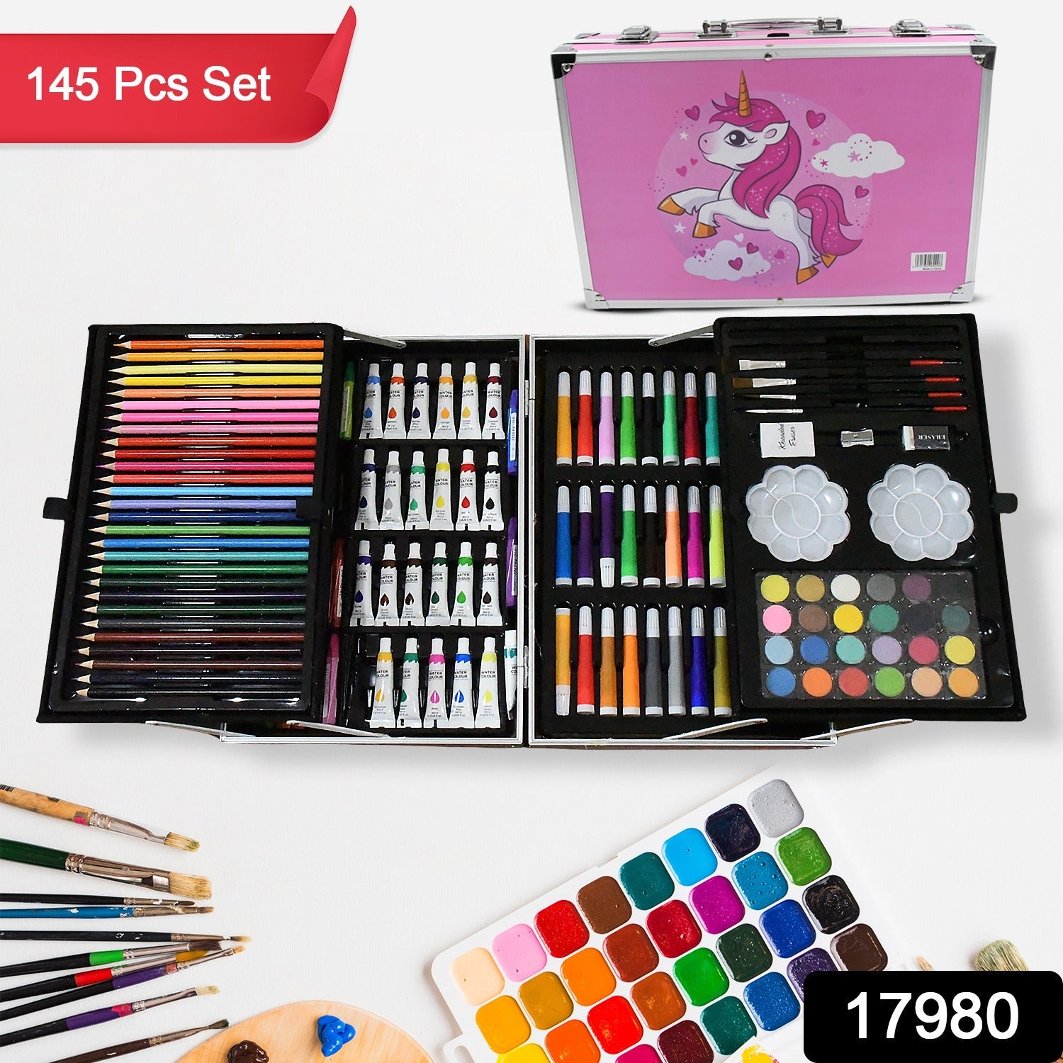 Close-up of the art set's contents, showing colorful crayons, oil pastels, and watercolor cakes.