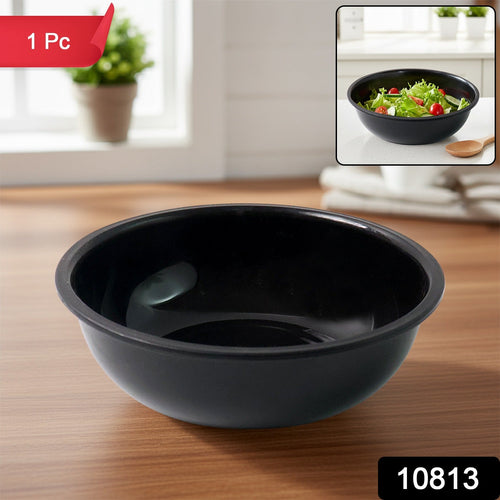 Black plastic serving bowl filled with curry showing deep design